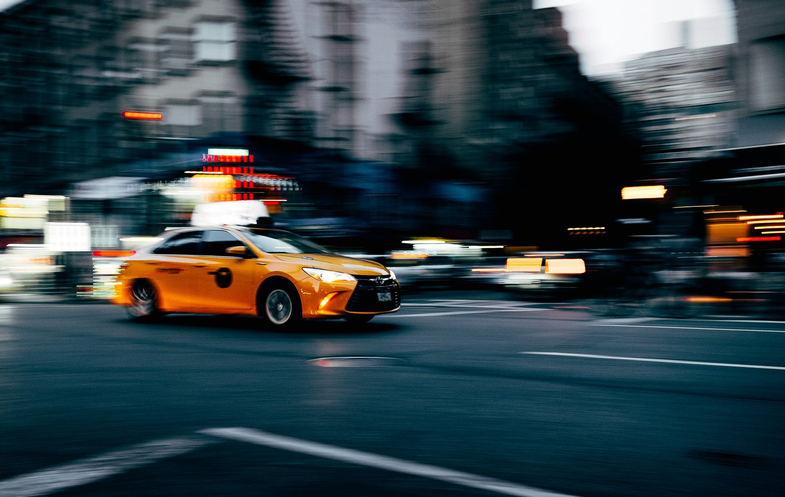 Premium luxury car available for rental on scenic highway at golden hour